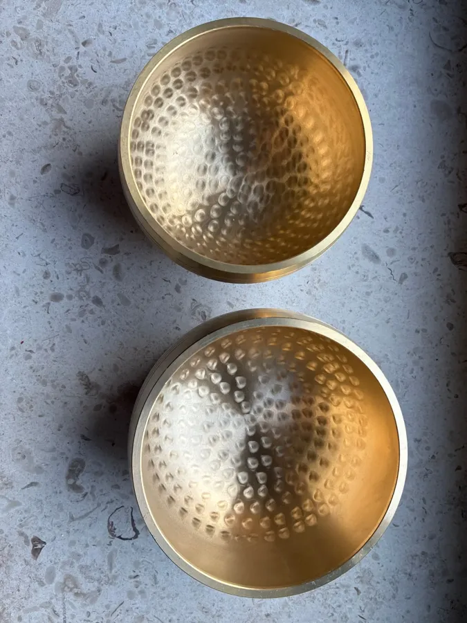 Verified buyer photo of two small brass singing bowls seen from above