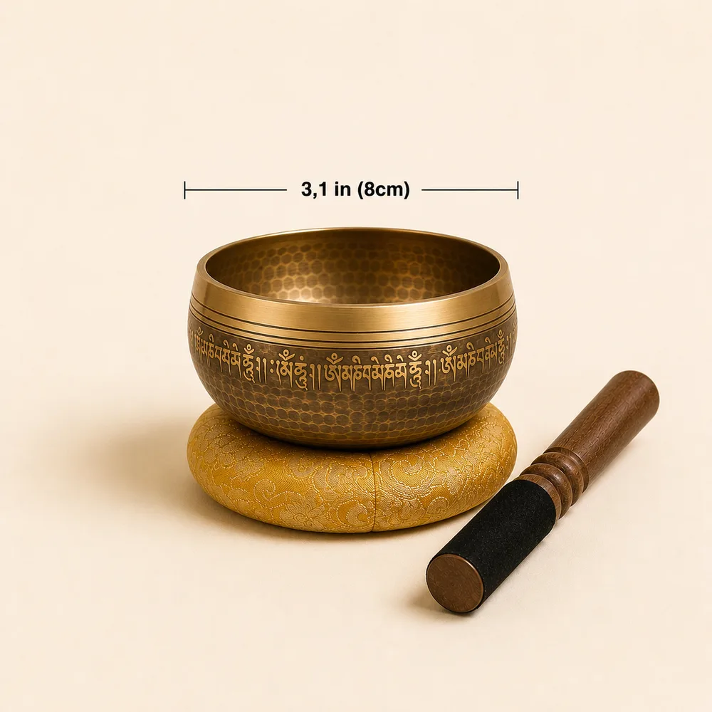 Engraved Nadam singing bowl set on its yellow silk cushion with the two-head mallet